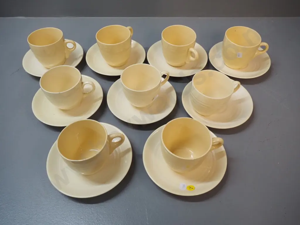9 early Crown Lynn cups & saucers, varying shades of yellow, 2 cups have chips Image 1++