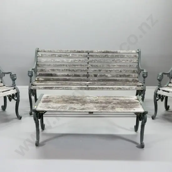 4-piece Victorian style outdoor setting with bench, 2 chairs & low table, cast iron lion head ends. Some wobbling - aged