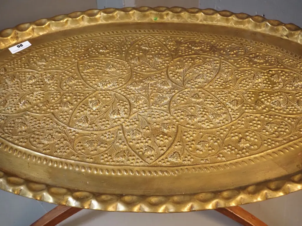 beaten brass tray / table with grape motifs on folding timber base - H-420 L-930 W-560 Image 1++