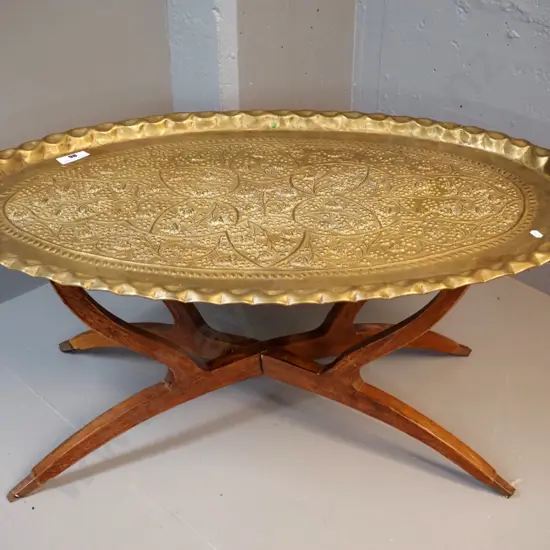 beaten brass tray / table with grape motifs on folding timber base - H-420 L-930 W-560