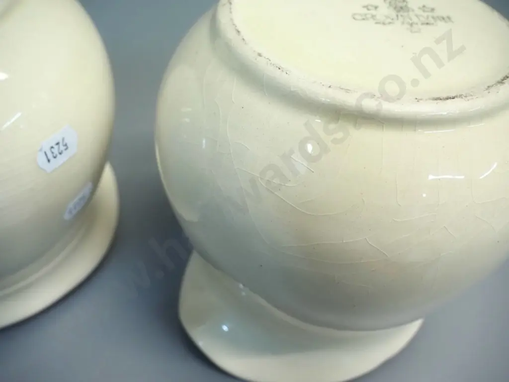 2 early Crown Lynn cream glaze milk jugs - one with tiki mark, both stamped 709-3. Some crazing. H-140 W-170 at handle Image 1++