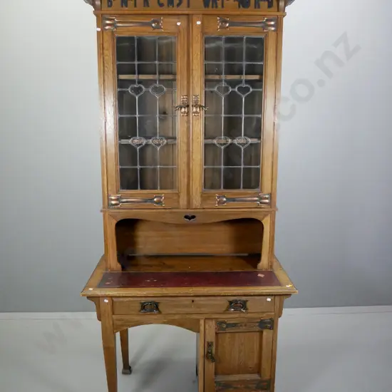 Arts & crafts oak writing desk w/glazed bookcase top w/copper handles & strap hinges, applique timber motto,