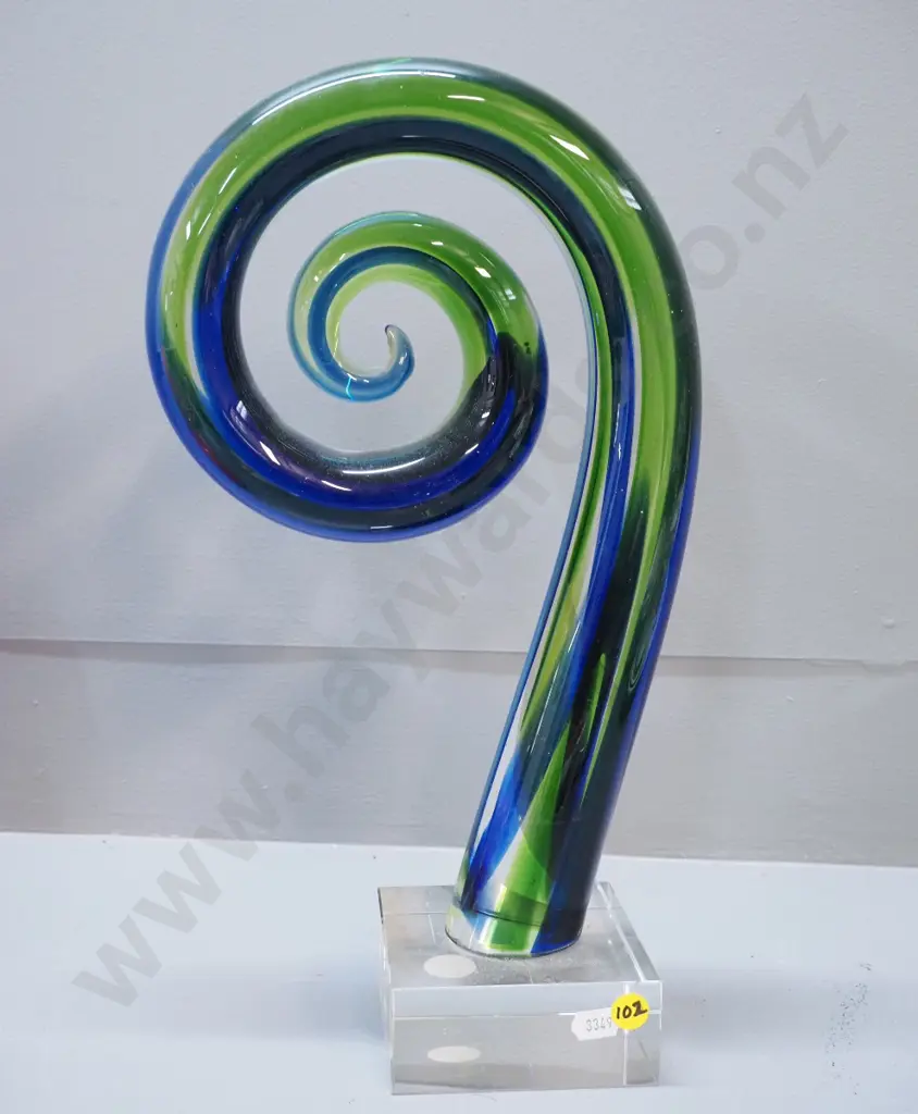 art glass blue & green koru on clear base, label reads The New Zealand Collection - Limited Edition H380 Image 1++