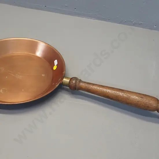 ornamental copper pan, wooden handle has brass collar, pan marked Soho Foundry Ballarat L-610 Pan D-270