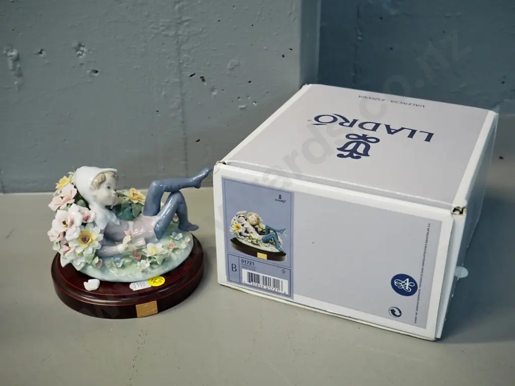 Lladro figure of pixie reclining in flowers, 1 leaf chipped off. H100 L130, comes with composite base & original box Image 1++
