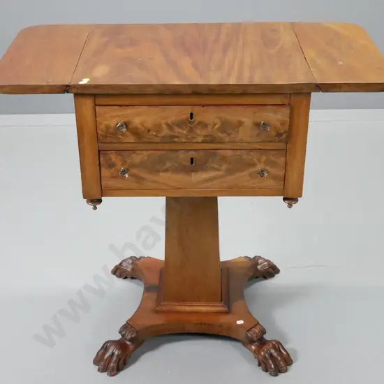 antique mahogany work table with drop-leaf ends, flame veneer drawer fronts, square pedestal base with claw feet