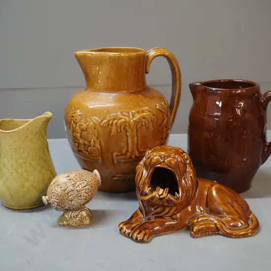assorted pottery items including lion ashtray, Beswick Beneagles miniature, 3 jugs w/no maker's marks - largest is H-210