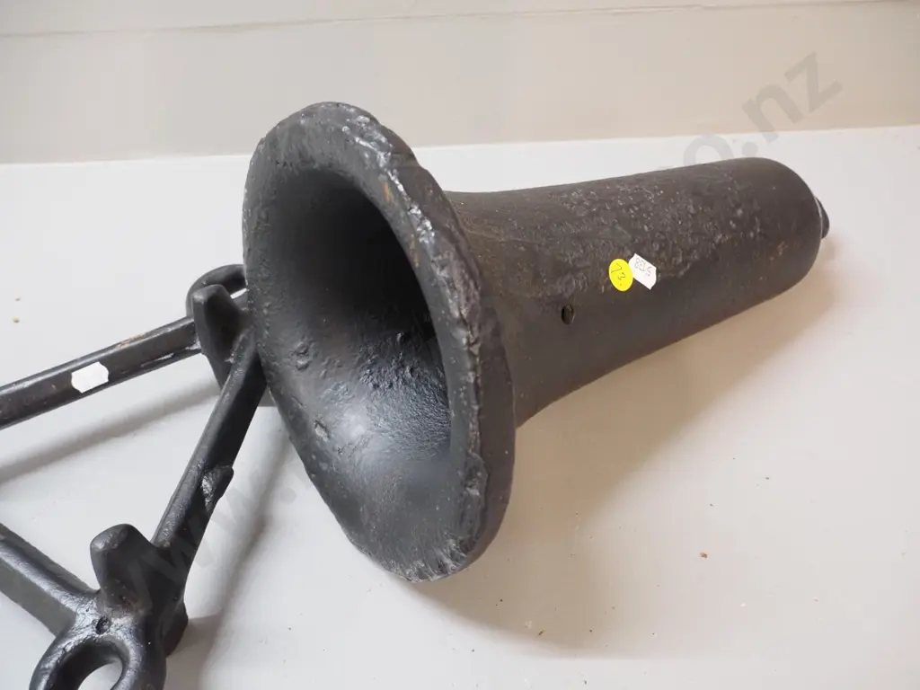 heavy gauge cast iron bell-shaped object with hanging loop and hole drilled H350 and a triangular frame with eyelets Image 1++