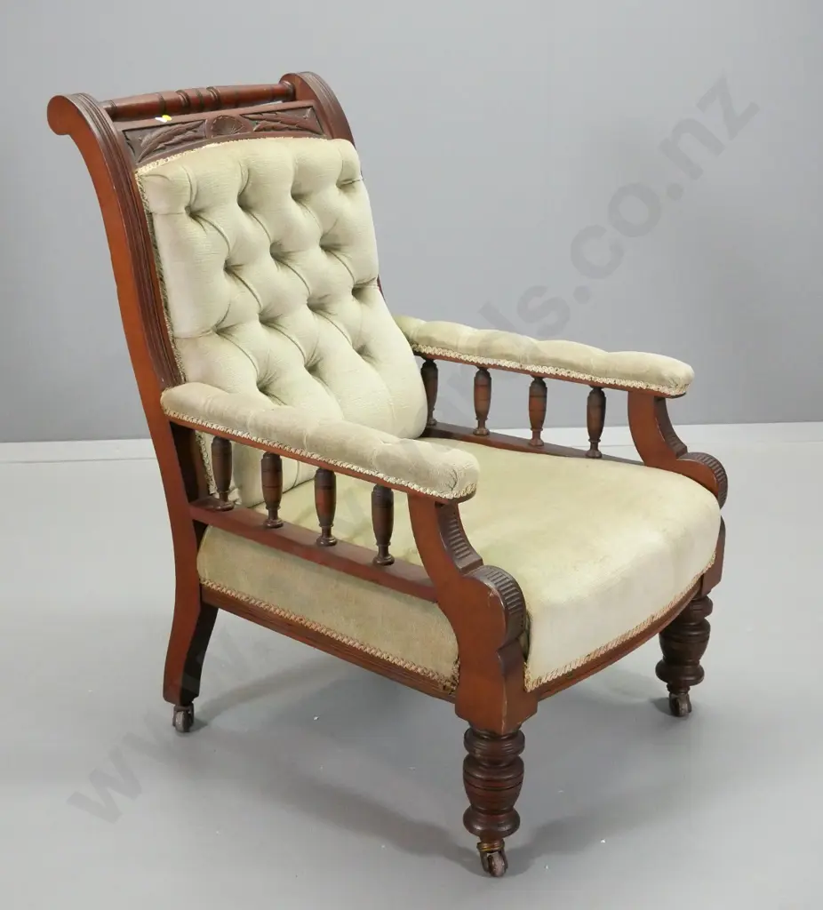 Edwardian gent's chair with carvedframe, spindles on arms, in deep-button green velvet, original porcelain casters Image 1++