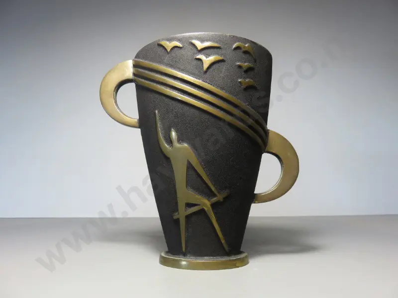 Mid-century brutalist metal vase featuring a figure in raised relief sat below a flock of birds Image 1++