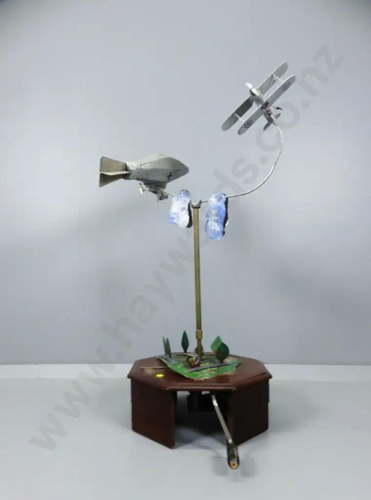 Early 20th century automaton featuring a world war one Biplane chasing a German Zeppelin Image 1++