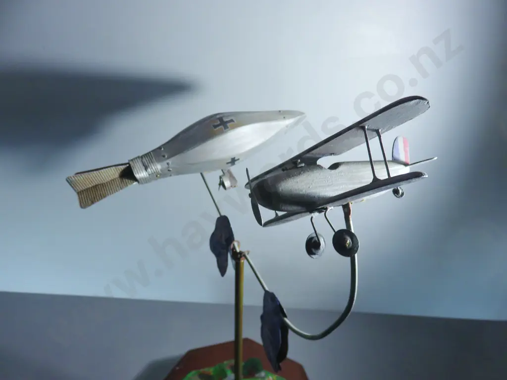 Early 20th century automaton featuring a world war one Biplane chasing a German Zeppelin Image 1++