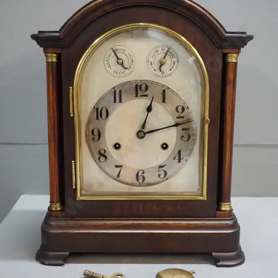timber cased chiming mantel clock with brass fittings, columns on front, no maker's mark on movement H380 W300 D170