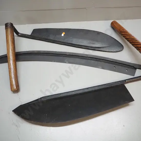 2 vintage hay knives with wooden handles and a large scythe blade - 2 are marked W. Tyzack