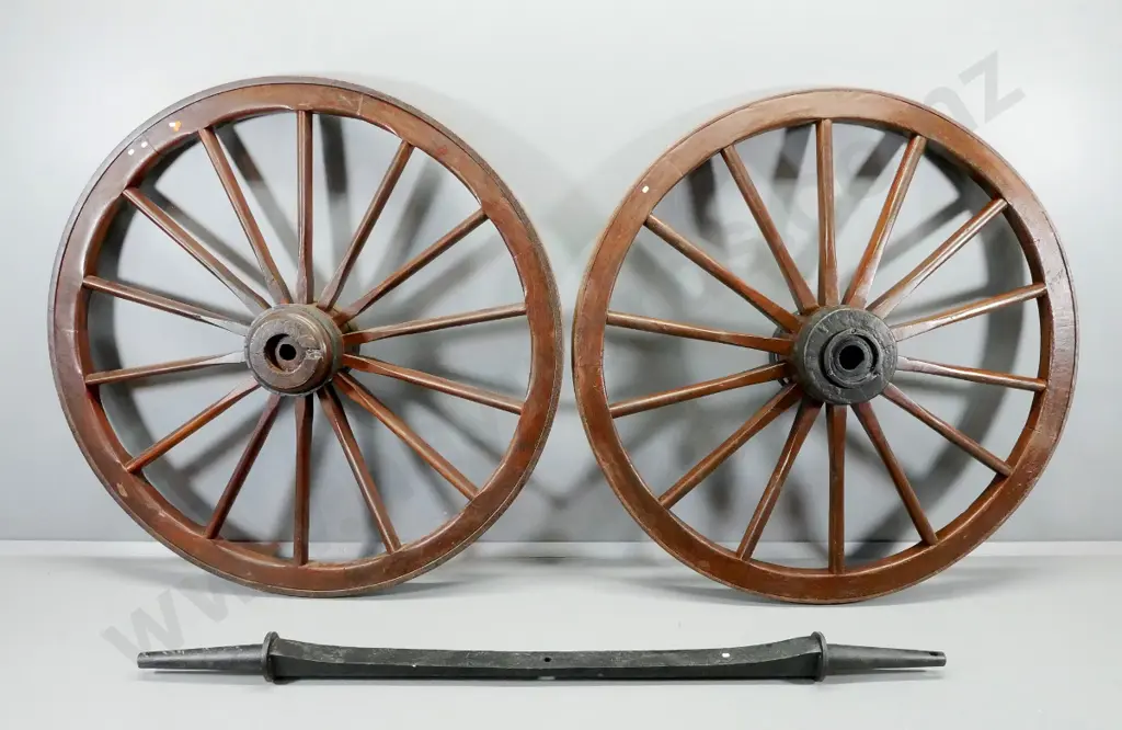 2 large dray wheels and a cast iron axle with tapered ends L-2110, Wheels have iron bands D-1490 Image 1++