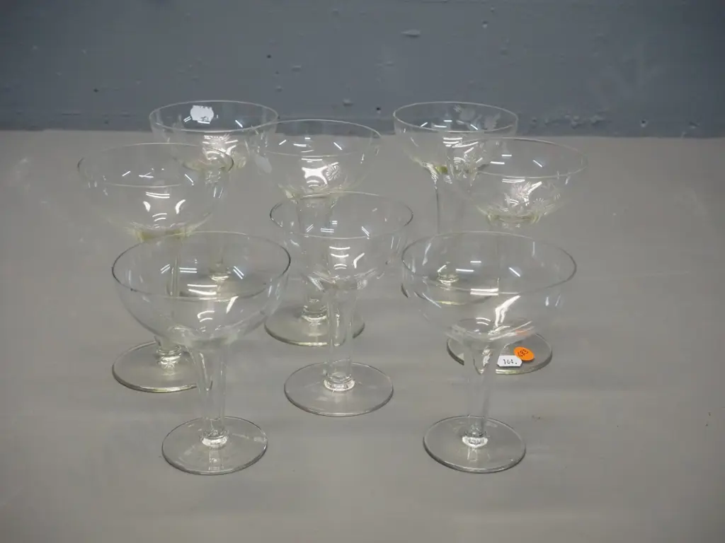 8 hollow-stemmed champagne glasses, 3 different styles/sizes, 5 larger w/etched motif H-130, one with slight chip on rim Image 1++