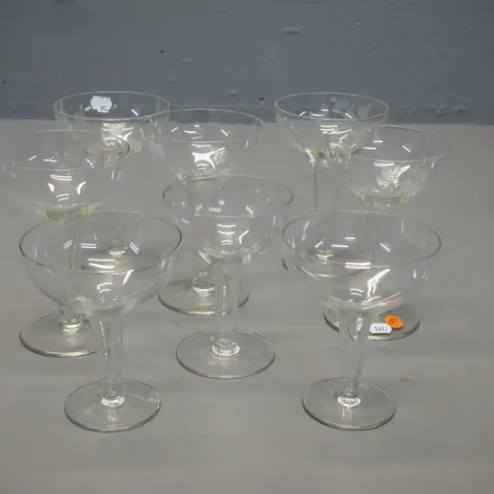 8 hollow-stemmed champagne glasses, 3 different styles/sizes, 5 larger w/etched motif H-130, one with slight chip on rim