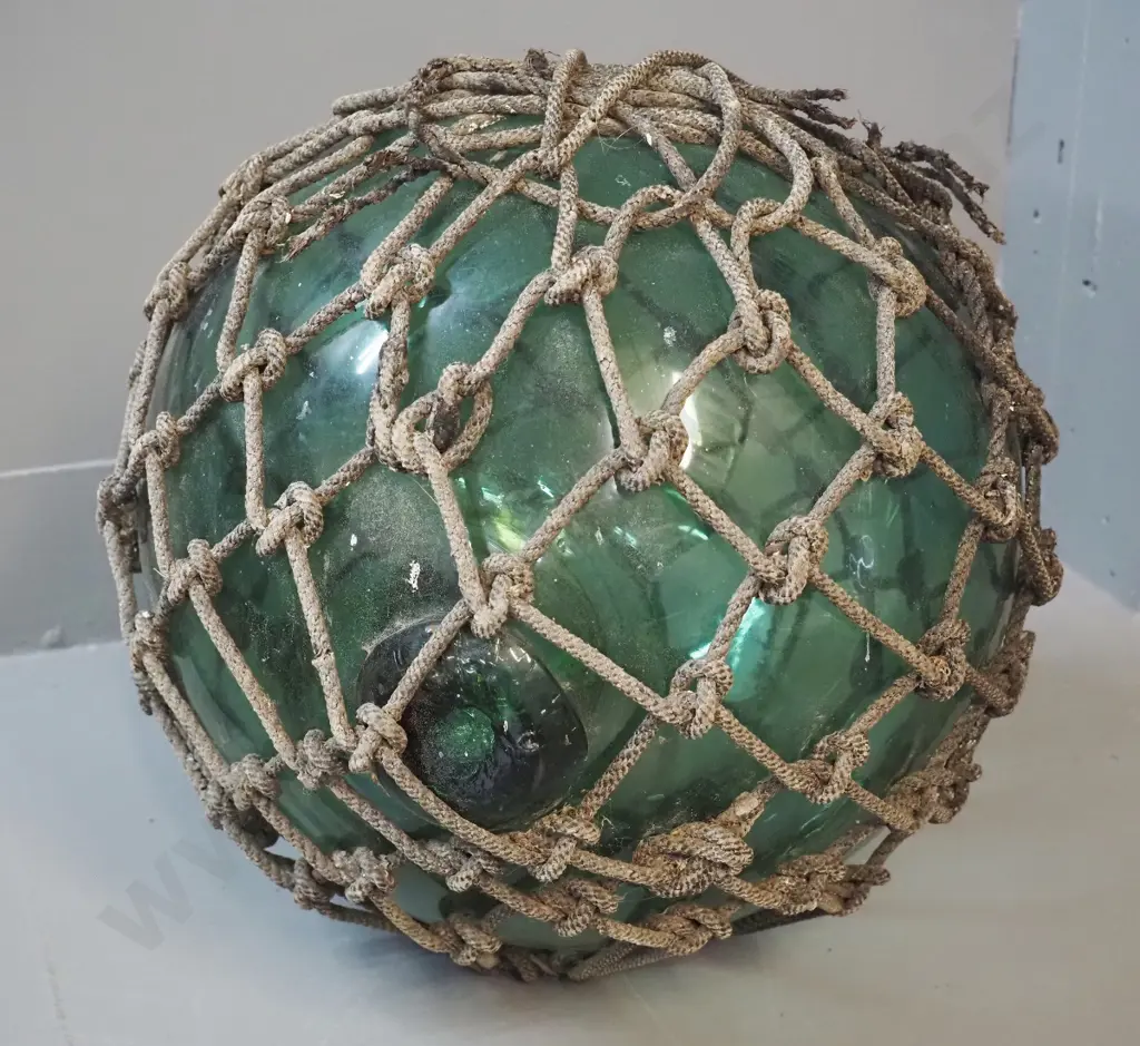 vintage green glass fishing float with rope netting surround - netting is coming apart in places D-300 Image 1++