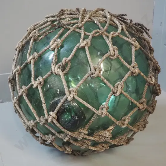 vintage green glass fishing float with rope netting surround - netting is coming apart in places D-300
