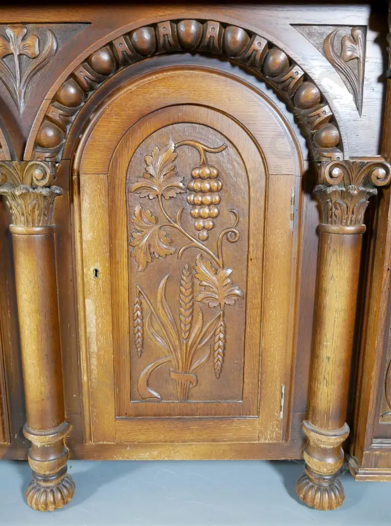 large heavily carved oak tudor style sideboard w/arched column drawers, lockable, with key, split to one door Image 1++