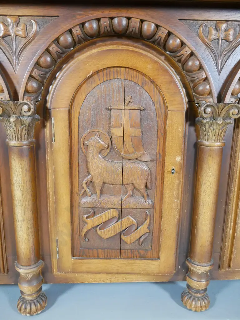 large heavily carved oak tudor style sideboard w/arched column drawers, lockable, with key, split to one door Image 1++
