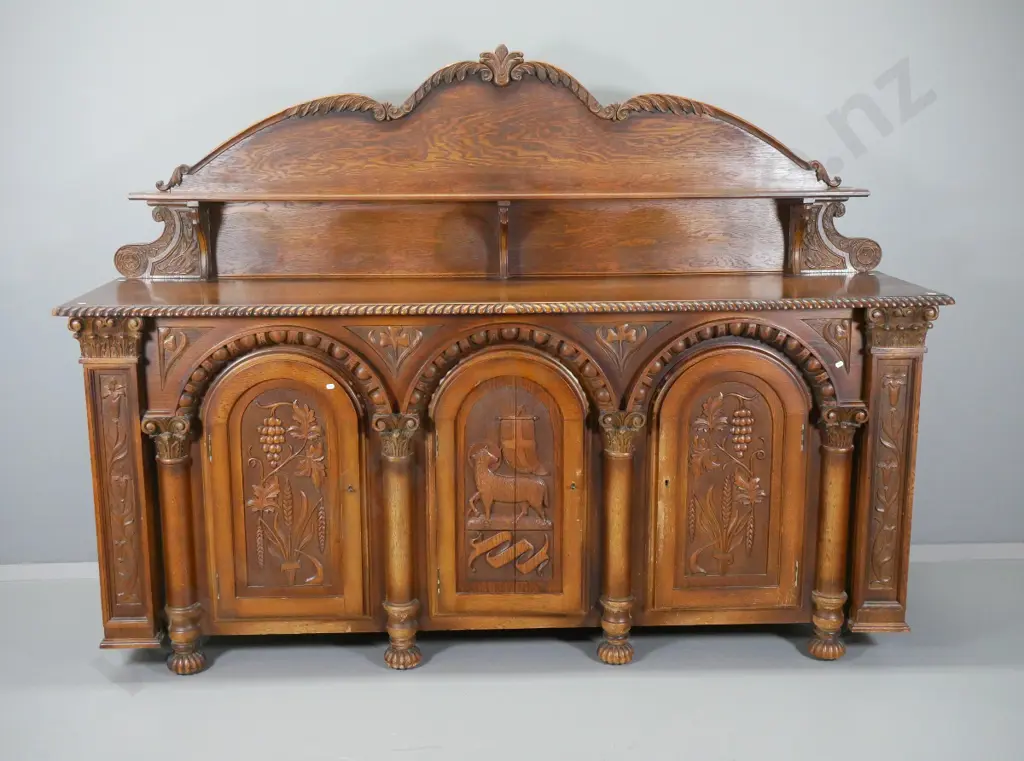 large heavily carved oak tudor style sideboard w/arched column drawers, lockable, with key, split to one door Image 1++