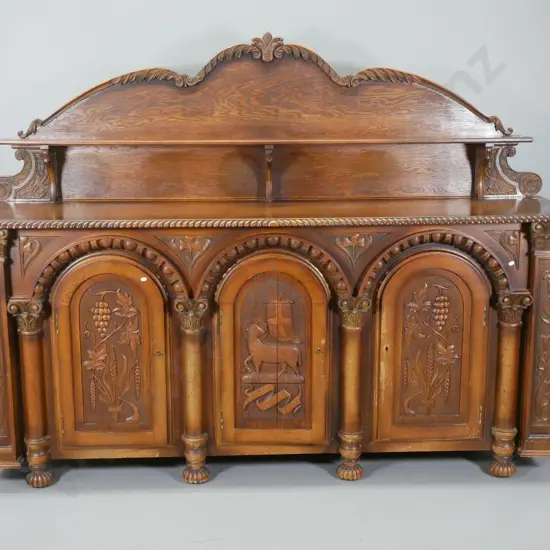 large heavily carved oak tudor style sideboard w/arched column drawers, lockable, with key, split to one door