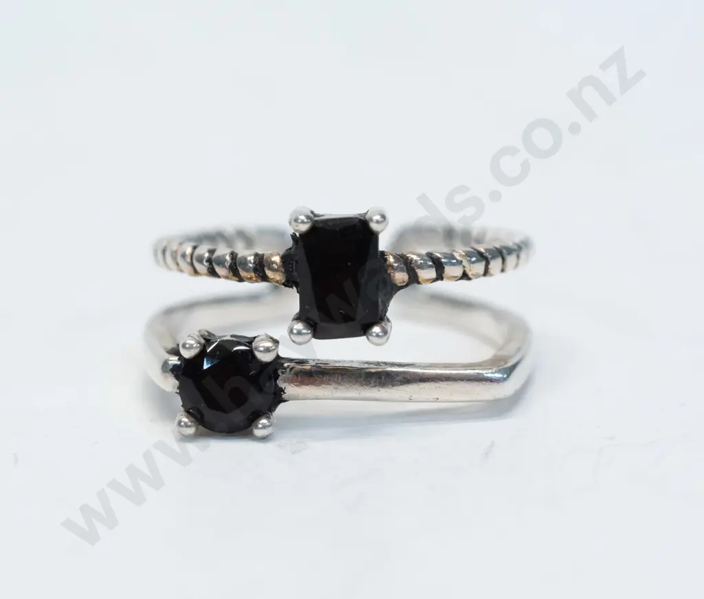 silver double ring with dark stones joined together at base stamped 925 Image 1++