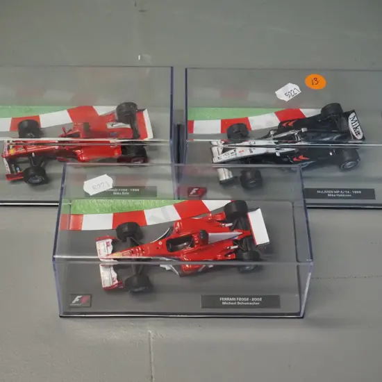 3 die-cast 1:43 scale Formula 1 racing cars - 1999 Mika Hakkinen, 1999 Mika Salo, 2002 Michael Schumacher,