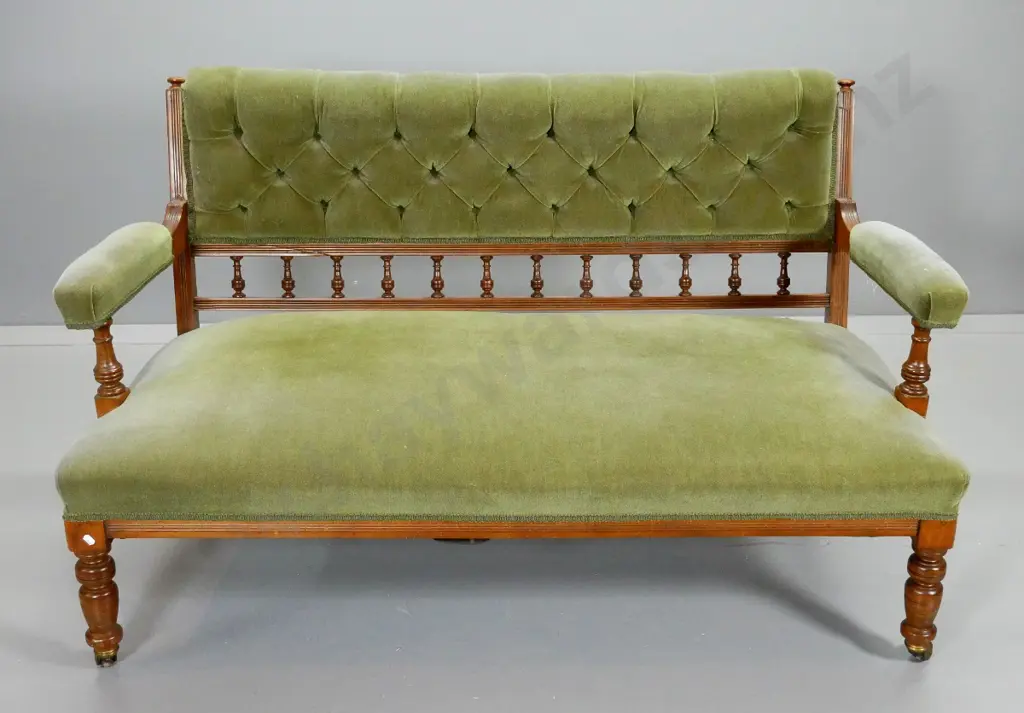 vintage settee with turned legs and spindles, deep button back, green velvet upholstery, on porcelain casters H810 W1380 Image 1++