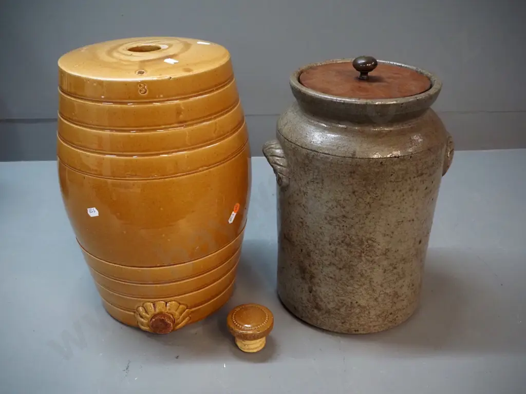 2 stoneware crocks - dispensing barrel shaped crock with chip to stopper & mouth H370, storage crock with wooden lid Image 1++