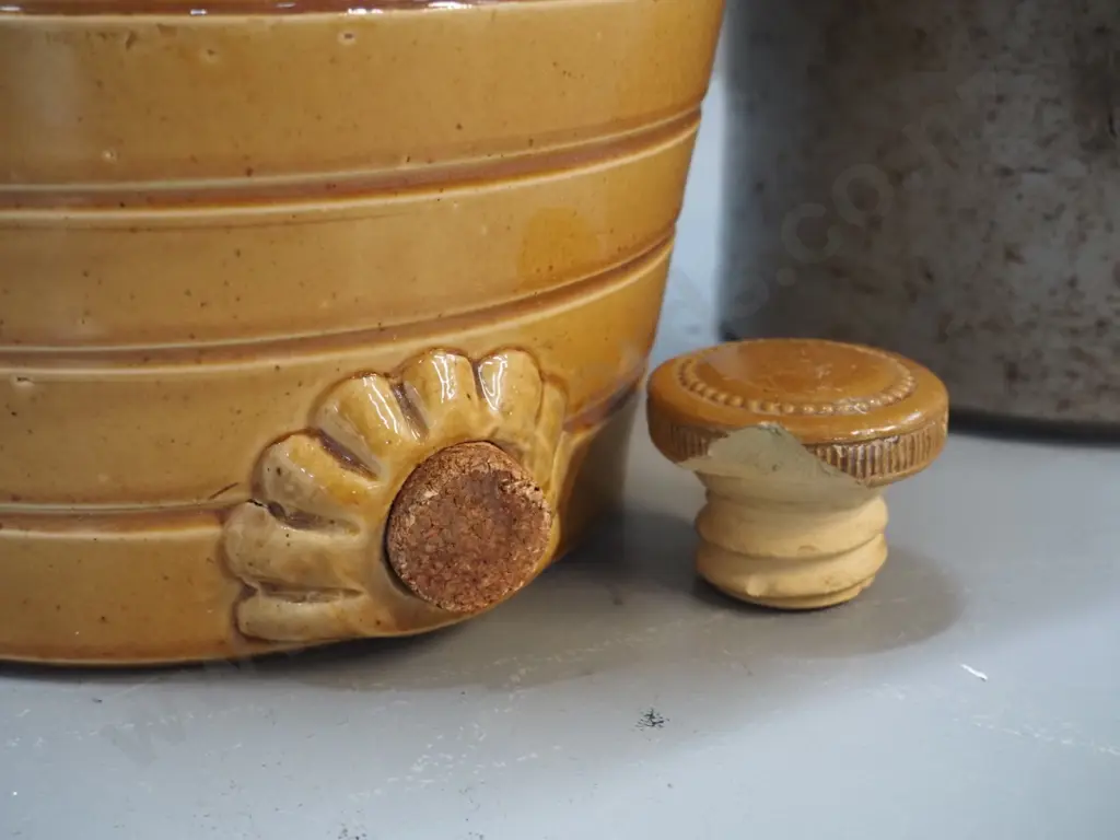 2 stoneware crocks - dispensing barrel shaped crock with chip to stopper & mouth H370, storage crock with wooden lid Image 1++