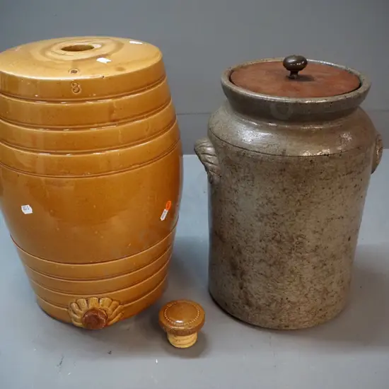 2 stoneware crocks - dispensing barrel shaped crock with chip to stopper & mouth H370, storage crock with wooden lid