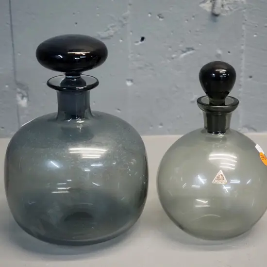 2 smoked glass stoppered bottles - larger H200, other has Sussmuth label, both need cleaning inside