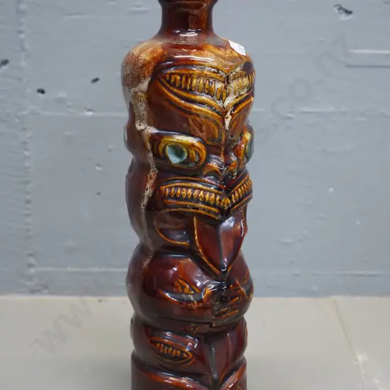 Titoki stoneware Maori tiki motif bottle, stamped 9914. H-300