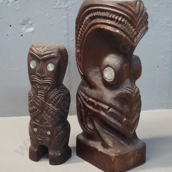 two carved wooden maori motif figures with paua inlay eyes - one with hole drilled in top is H-240