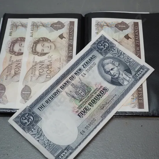 plastic wallet of New Zealand bank notes - 1 and 5 pound notes, Millennium $5 and other dollar notes, etc.