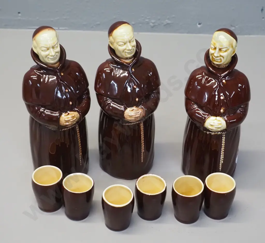 3 monk decanters with cork lined stoppers, two marked Beswick, other Kirkhams, and 6 cups, some marked Beswick Image 1++