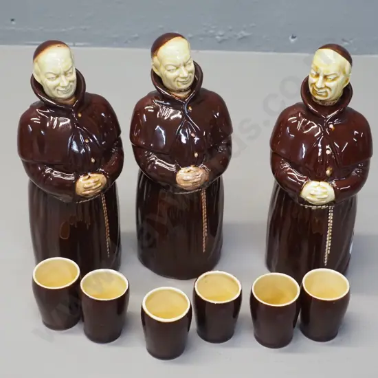 3 monk decanters with cork lined stoppers, two marked Beswick, other Kirkhams, and 6 cups, some marked Beswick