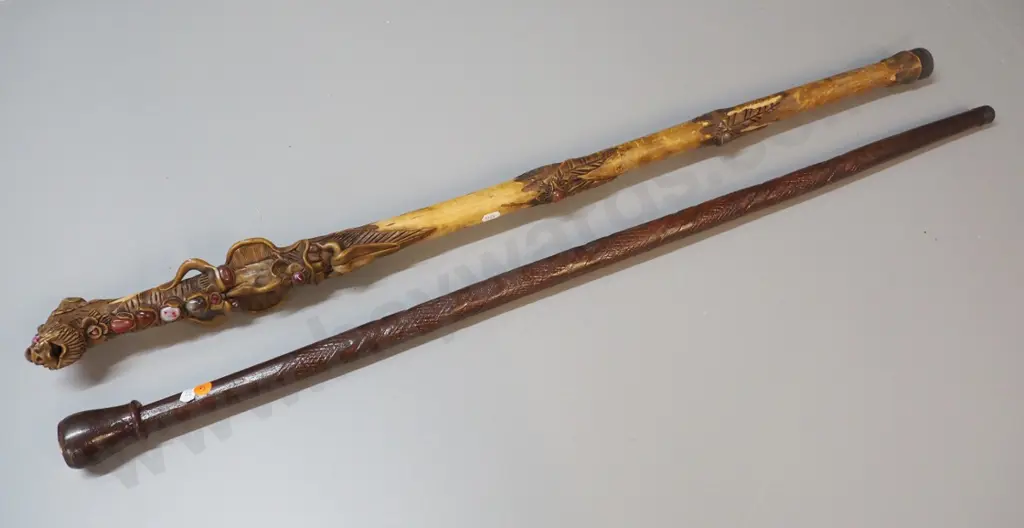 2 walking sticks - carved wood with  fantasy theme applied composite and stone, other carved wood with compass on top Image 1++