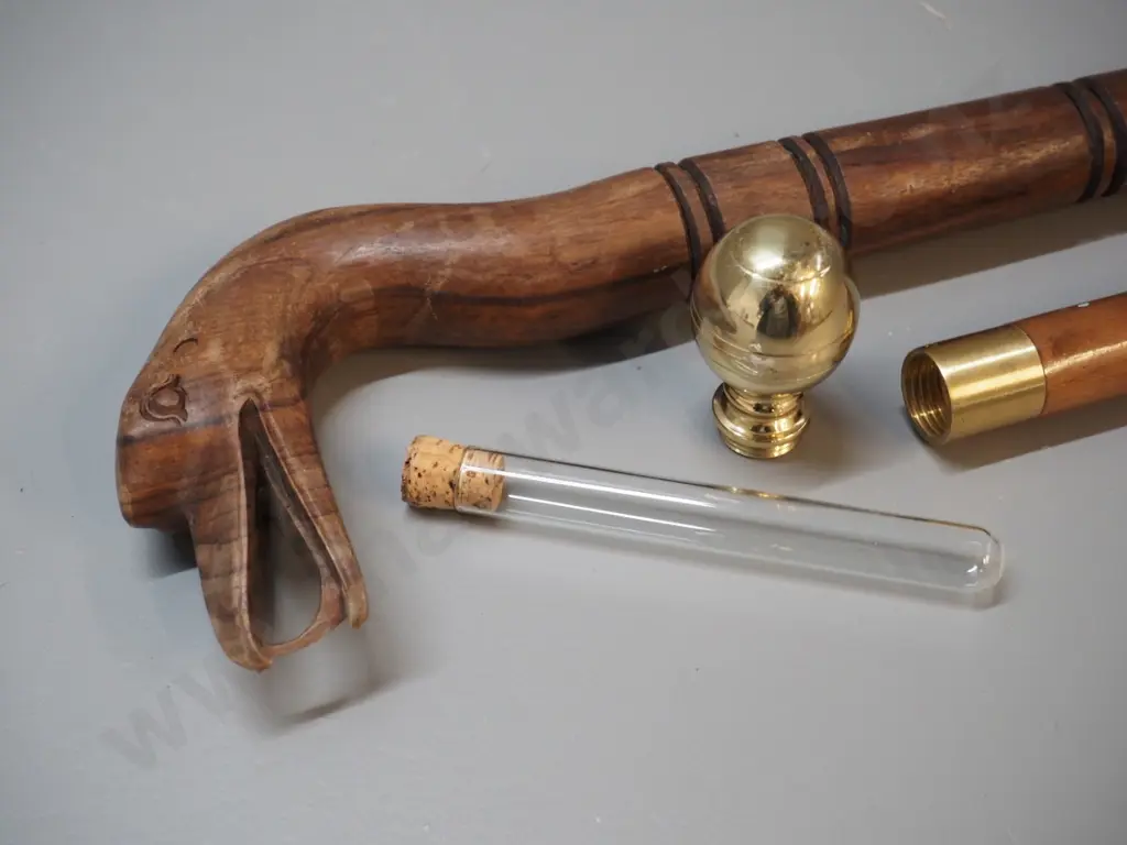 2 walking sticks - carved wood with bird motif head and a brass, other wood with glass vial under screw-top knob Image 1++