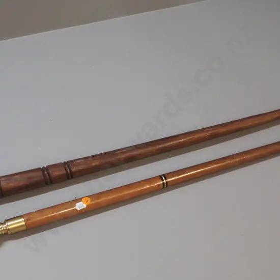 2 walking sticks - carved wood with bird motif head and a brass, other wood with glass vial under screw-top knob
