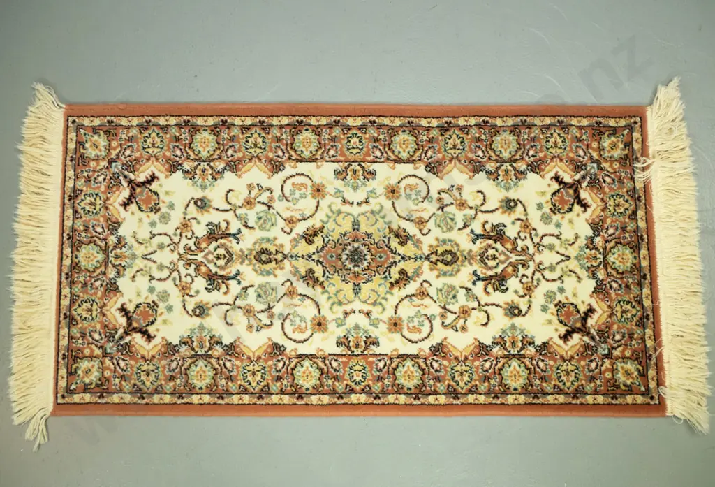2 small Persian style wool floor rugs - edged oval piece slightly faded, other slightly longer L970 W510 Image 1++