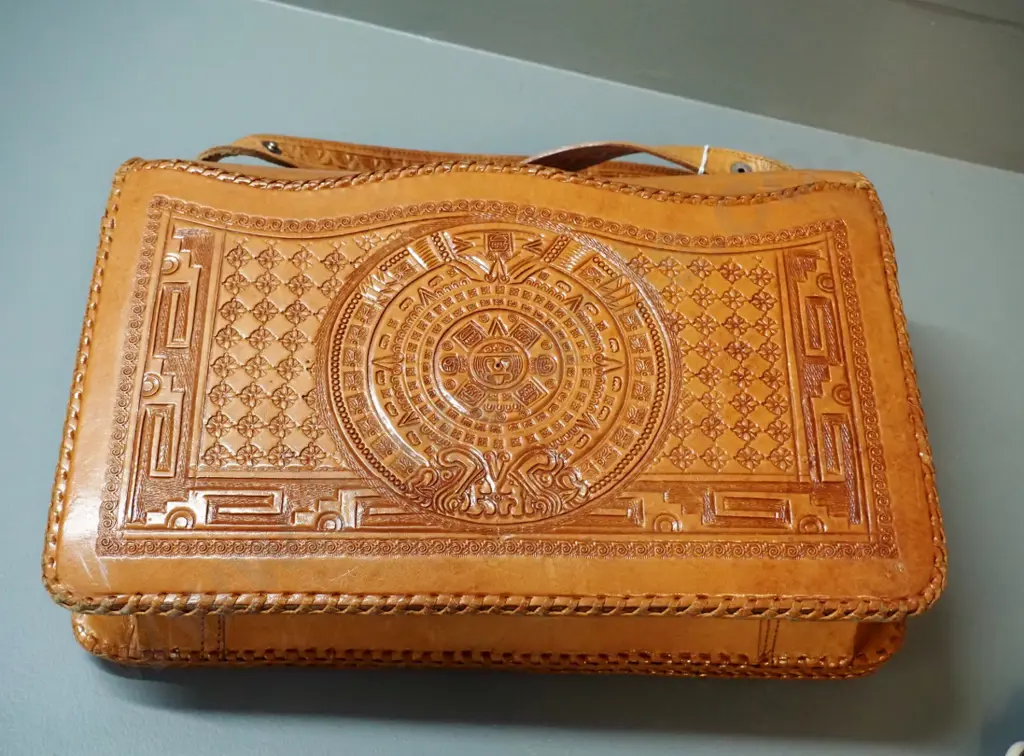 2 handbags - black cloth with shells & beads and hand-tooled (Mexican?) leather w/eagle and Aztec or Mayan motifs Image 1++