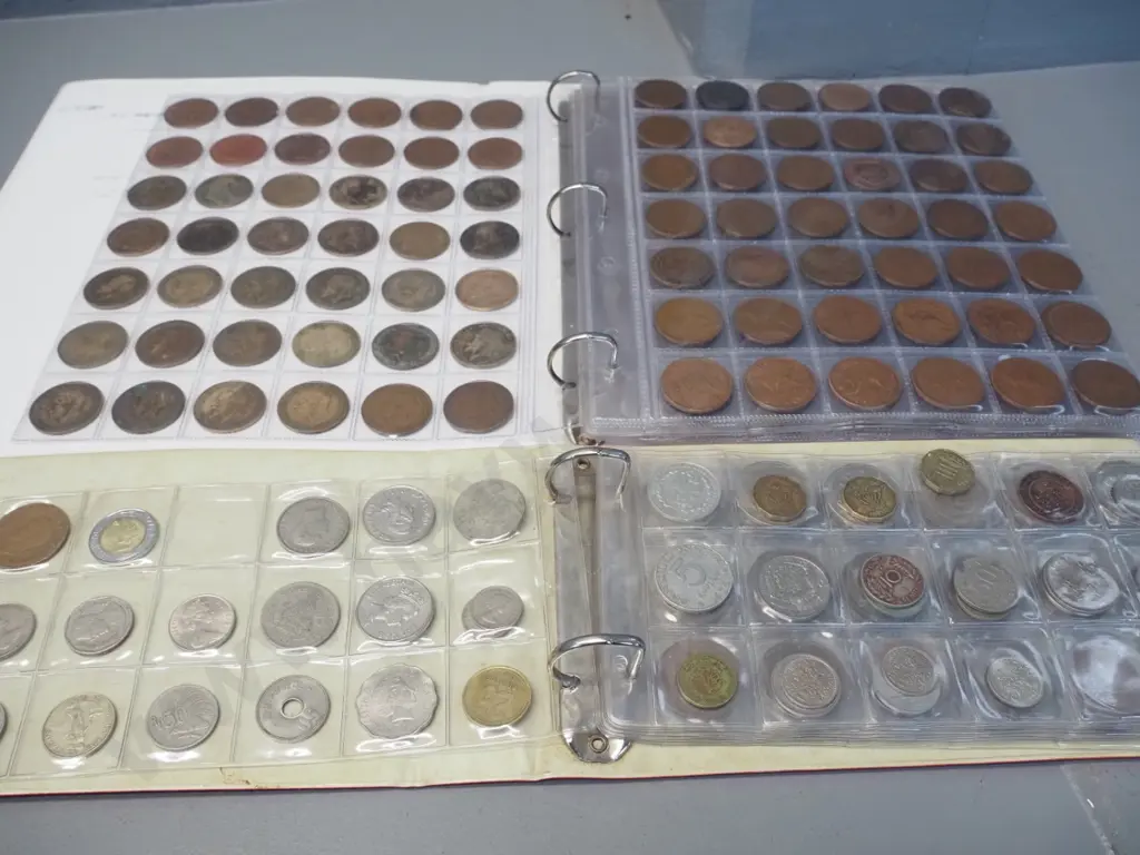 2 binders of assorted coins in sheets - NZ, Australian and English pennies etc. plus various international Image 1++
