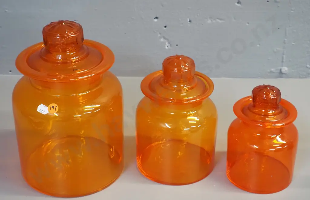 graduated set of 3 orange glass stoppered storage jars - largest is H-250 D-160 Image 1++
