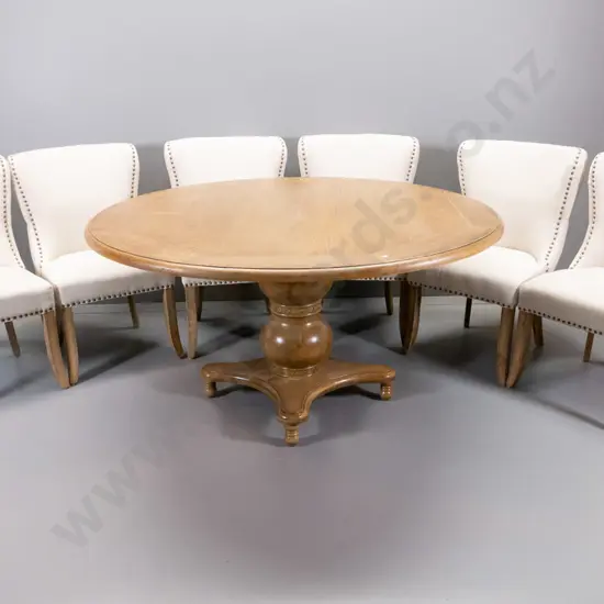 oak vintage-style round dining table with heavy pedestal base, 6 chairs with studded fabric, deep-button on backs.