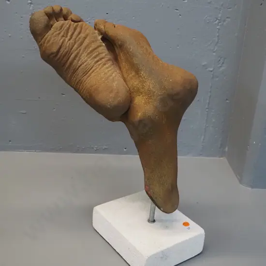 composite foot sculpture with faux oxidised metal finish on white stone base - finish has had some touch-ups H-470
