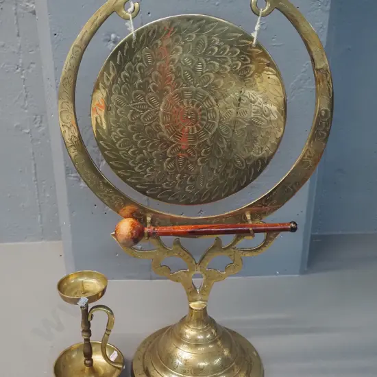 brass gong on stand with wooden beater H620 W-365 and a brass candlestick H-180