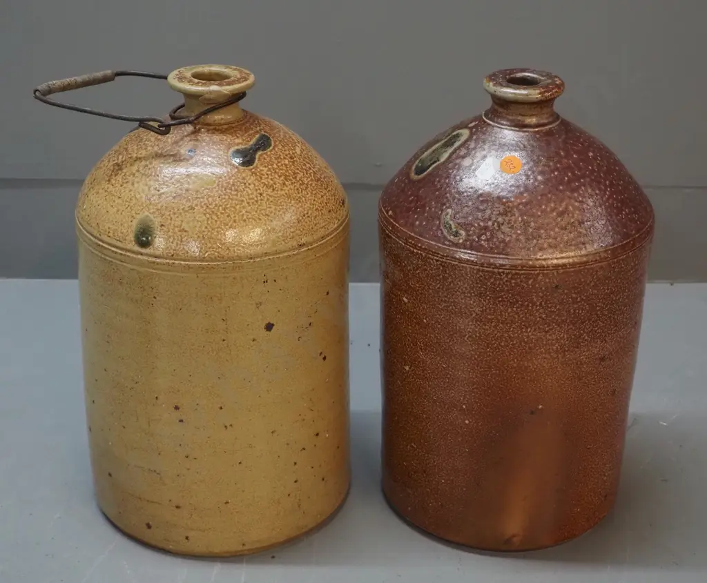 2 narrow-mouth salt-glazed crocks, one marked Luke Adams H310, other has wire handle Image 1++
